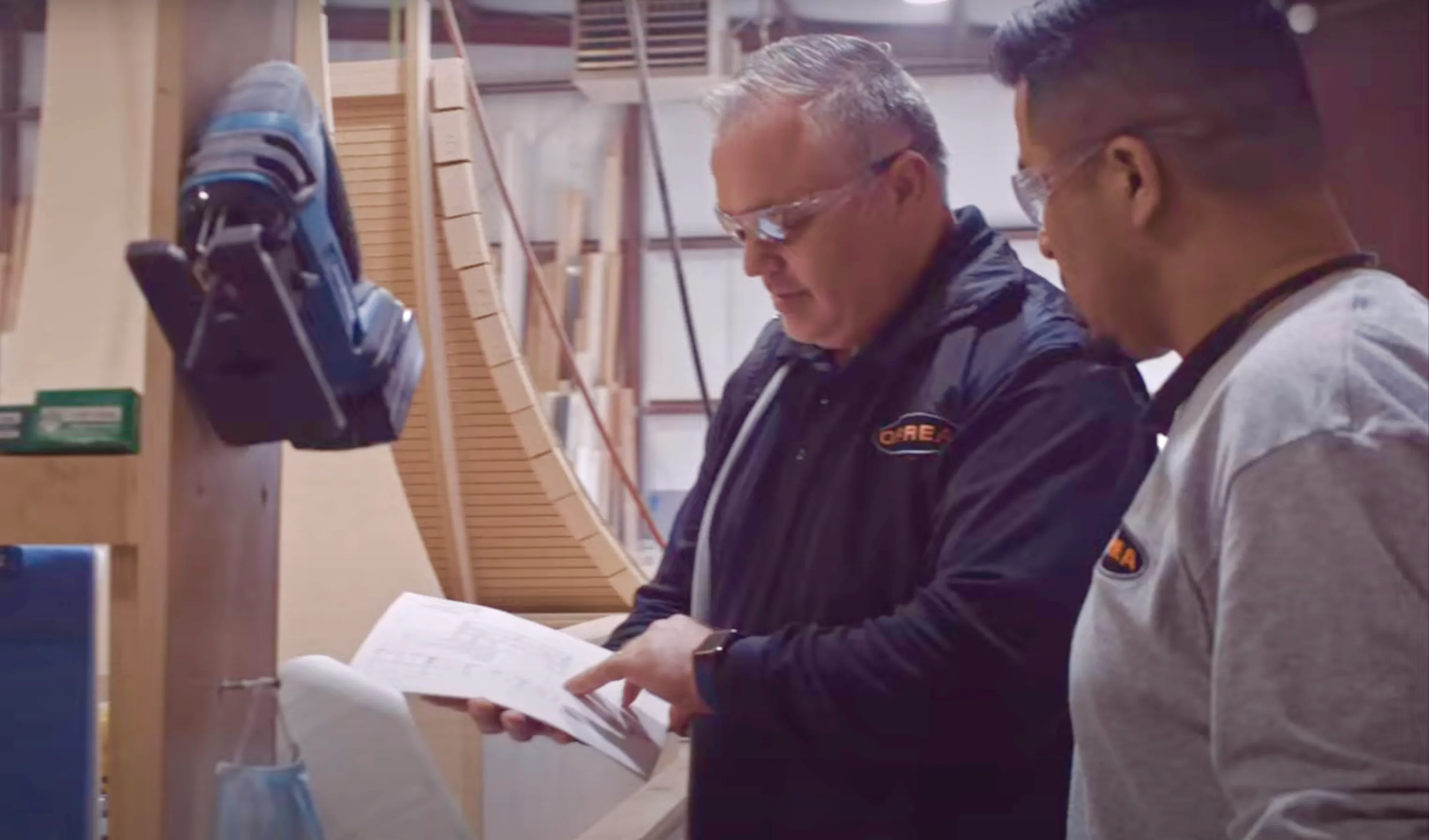 OPREA craftspeople reviewing a production drawing on the shop floor in Winder, Georgia